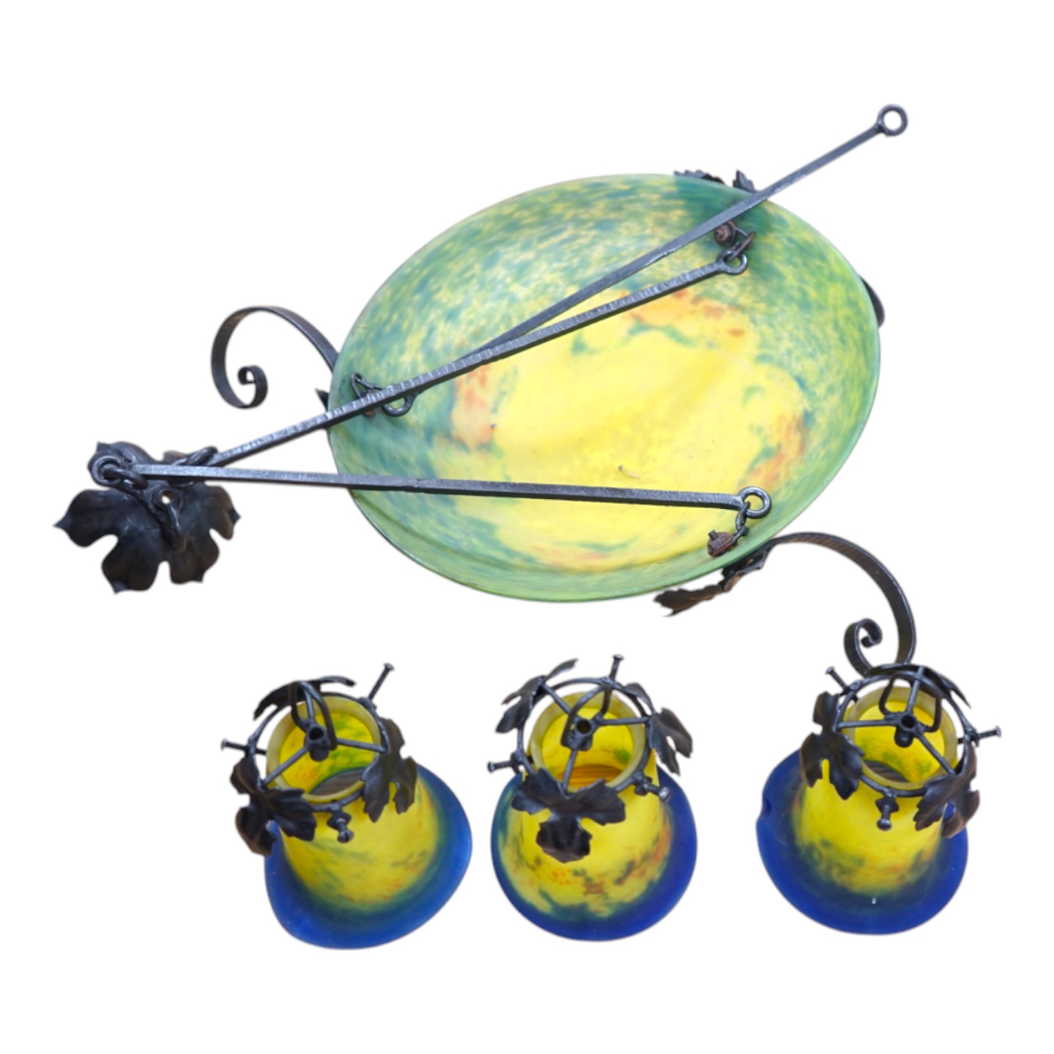 A French wrought iron chandelier with Pate de Verre plaffonier and three matching shades in yellow and blue, signed “Noverdy”, circa 1930’s, 66cm high from bottom of shade to ceiling rose, 58cm wide. Condition - good